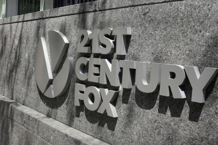 This Aug. 1, 2017, photo shows the 21st Century Fox sign outside of the News Corporation headquarters building in New York. (AP Photo/Richard Drew)