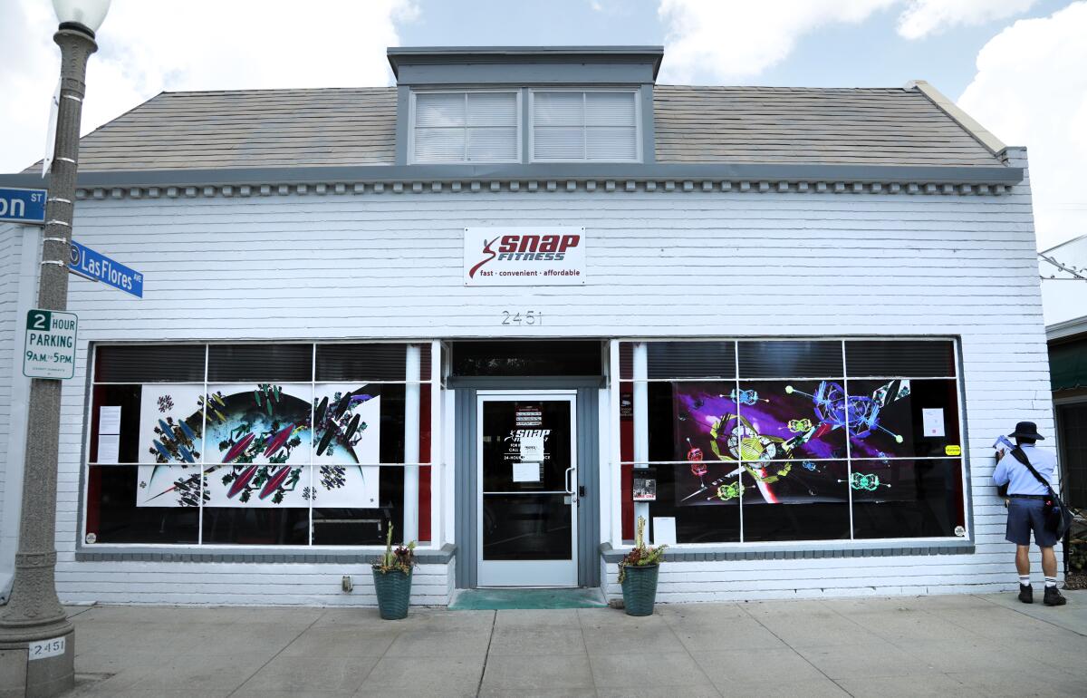 Ismael de Anda III's "The Sun Came Out Last Night and Sang to Me" is on display in the windows of a San Marino gym.