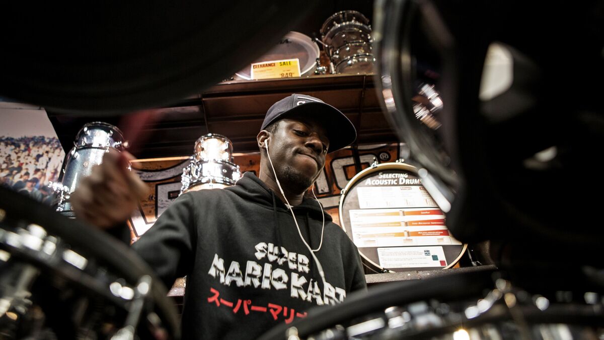 Musician Dra-Kkar Wesley frequently goes to Guitar Center to check out new equipment. Guitar Center has struggled in recent years, but company executives hope their latest business strategy can help sustain the retailer.