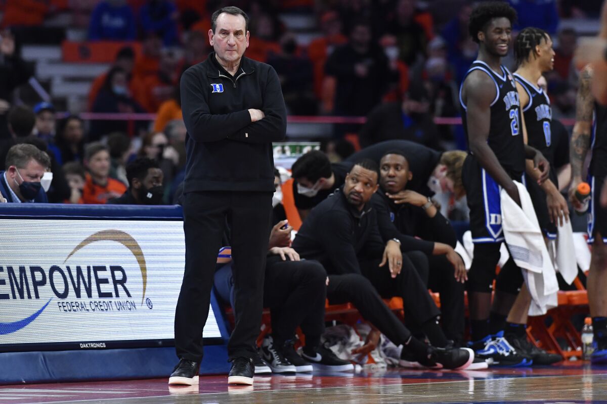 Duke coach Mike Krzyzewski watches from the sideline during the second half of the team's NCAA college basketball game against Syracuse in Syracuse, N.Y., Saturday, Feb. 26, 2022. Duke won 97-72. (AP Photo/Adrian Kraus)