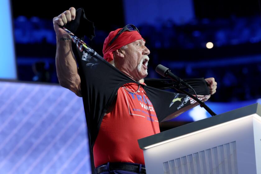 Hulk Hogan tears off shirt to reveal muscle tank underneath, on stage at the Republican National Convention
