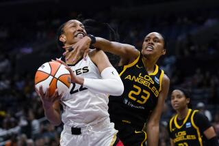 Las Vegas Aces forward A'ja Wilson (22) looks for a shot as Los Angeles Sparks forward Azura Stevens (23) defends during the first half of a WNBA basketball game Wednesday, July 12, 2023, in Los Angeles. (AP Photo/Ryan Sun)