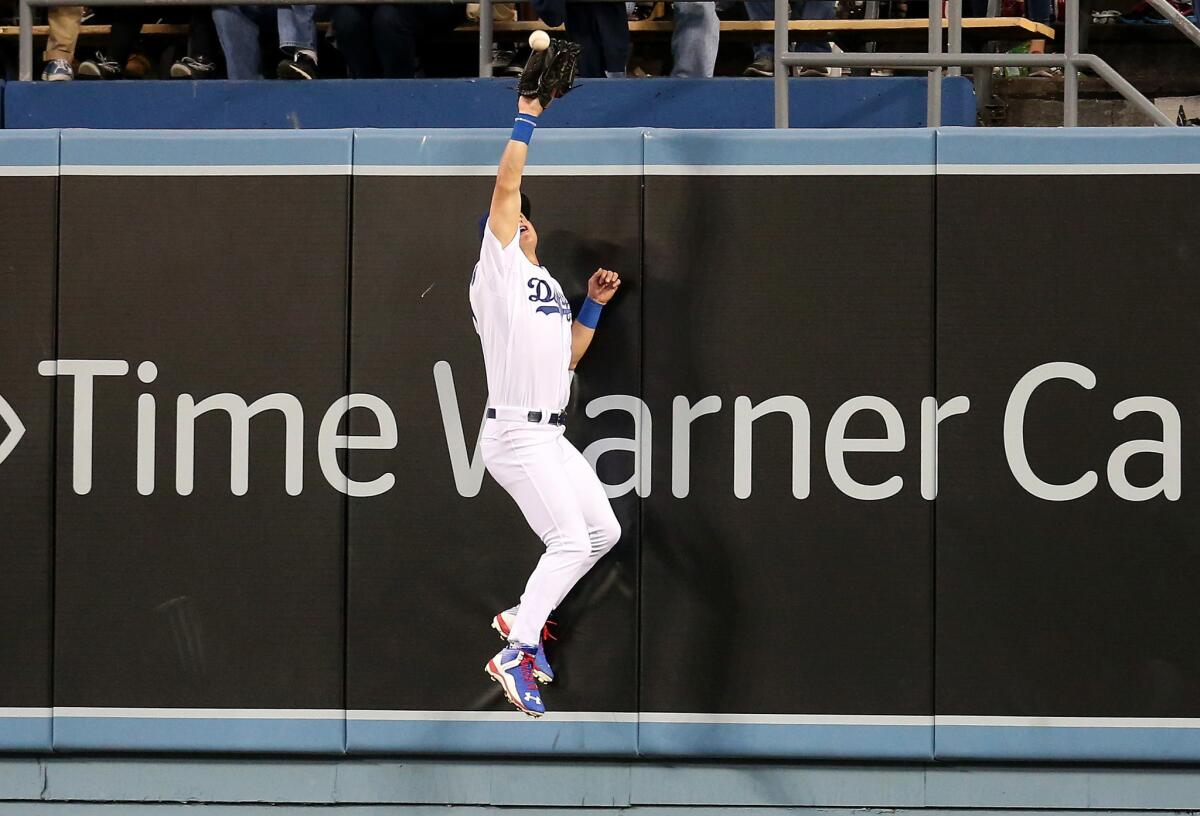 Dodgers center fielder Joc Pederson makes a home-run saving catch against the Diamondbacks.