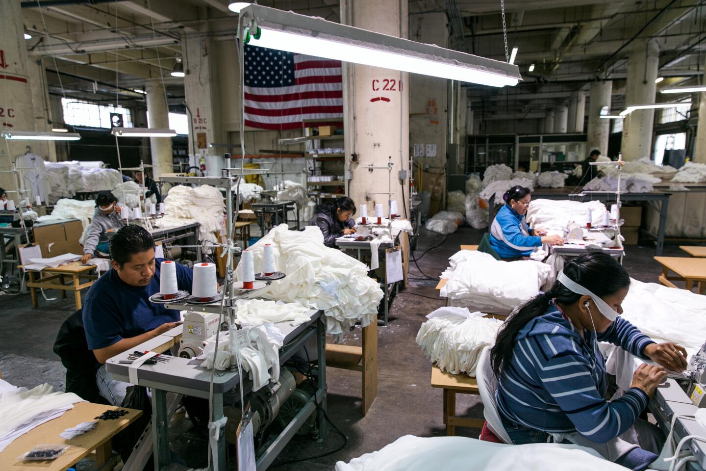 Employees at work at Groceries Apparel, a small garment factory in downtown Los Angeles. The company makes eco-chic clothing out of organic cotton and hemp.