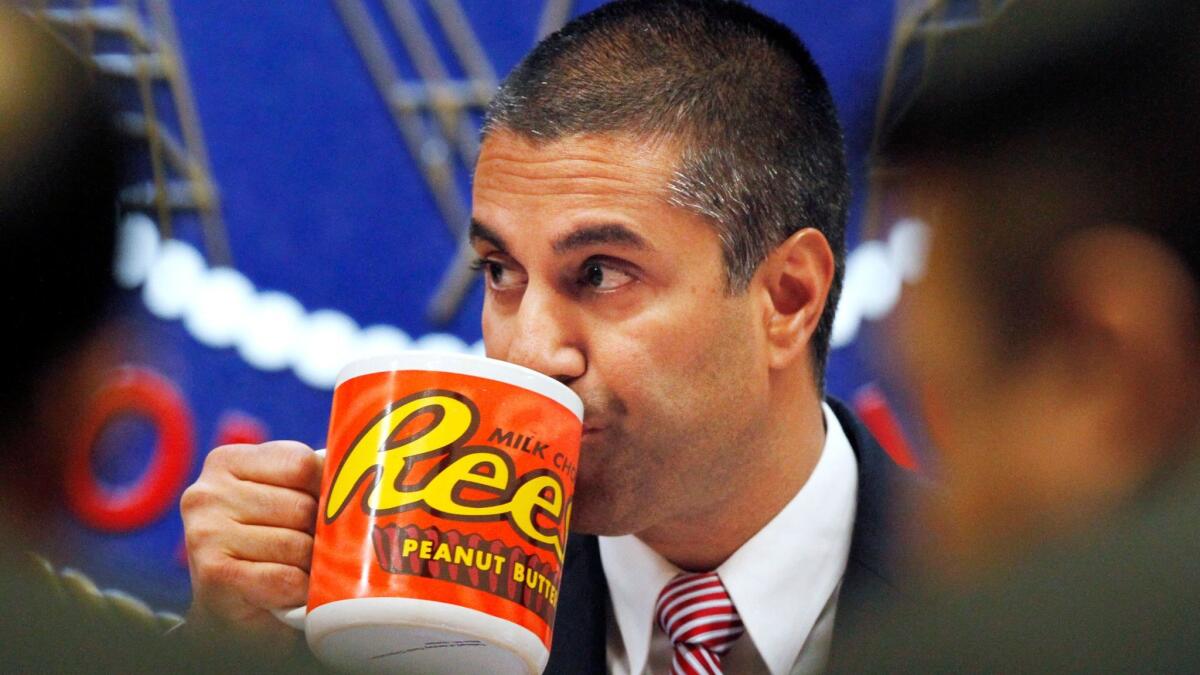 FCC Chairman Ajit Pai drinks from a mug during the Dec. 14 meeting in which his commission voted to end net neutrality rules.