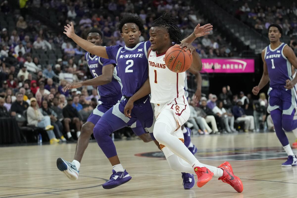 USC guard Isaiah Collier drives to the basket in front of Kansas State guard Tylor Perry.