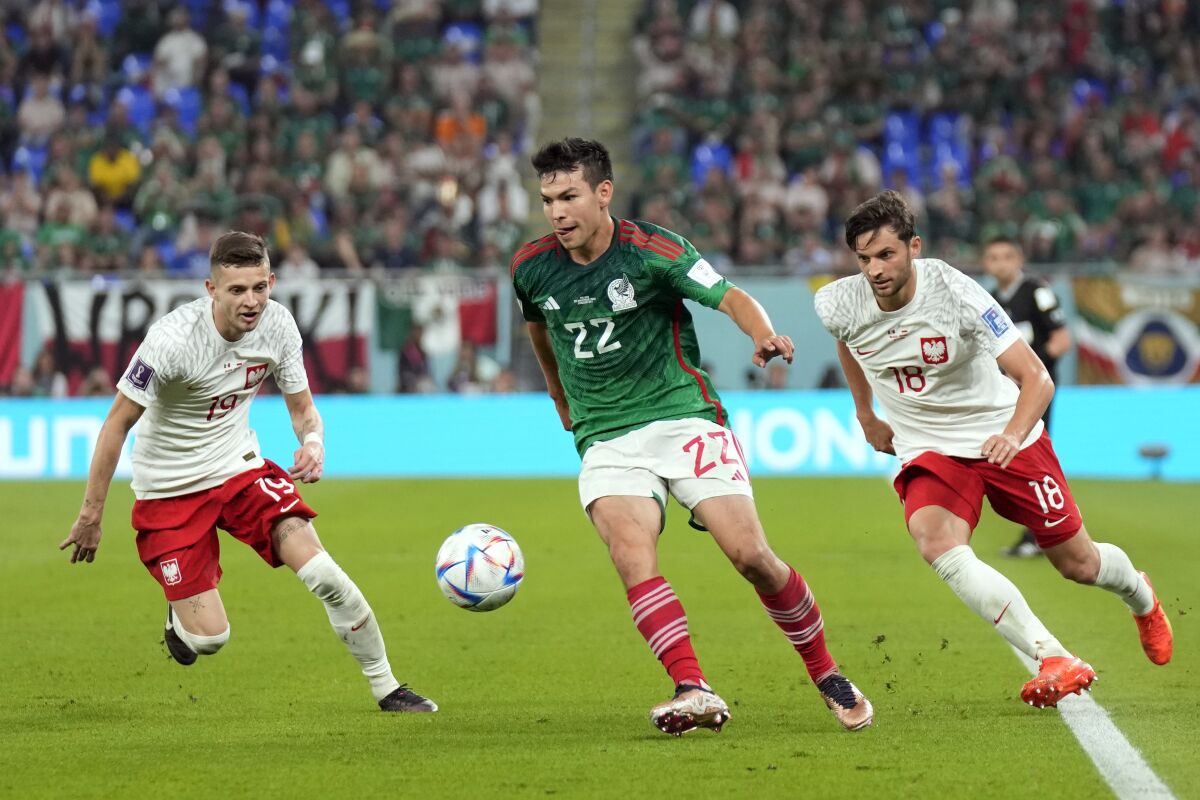 Mexico's Hirving "Chucky" Lozano battles for the ball, among Poland's Bartosz Bereszynski and Sebastian Szymanski