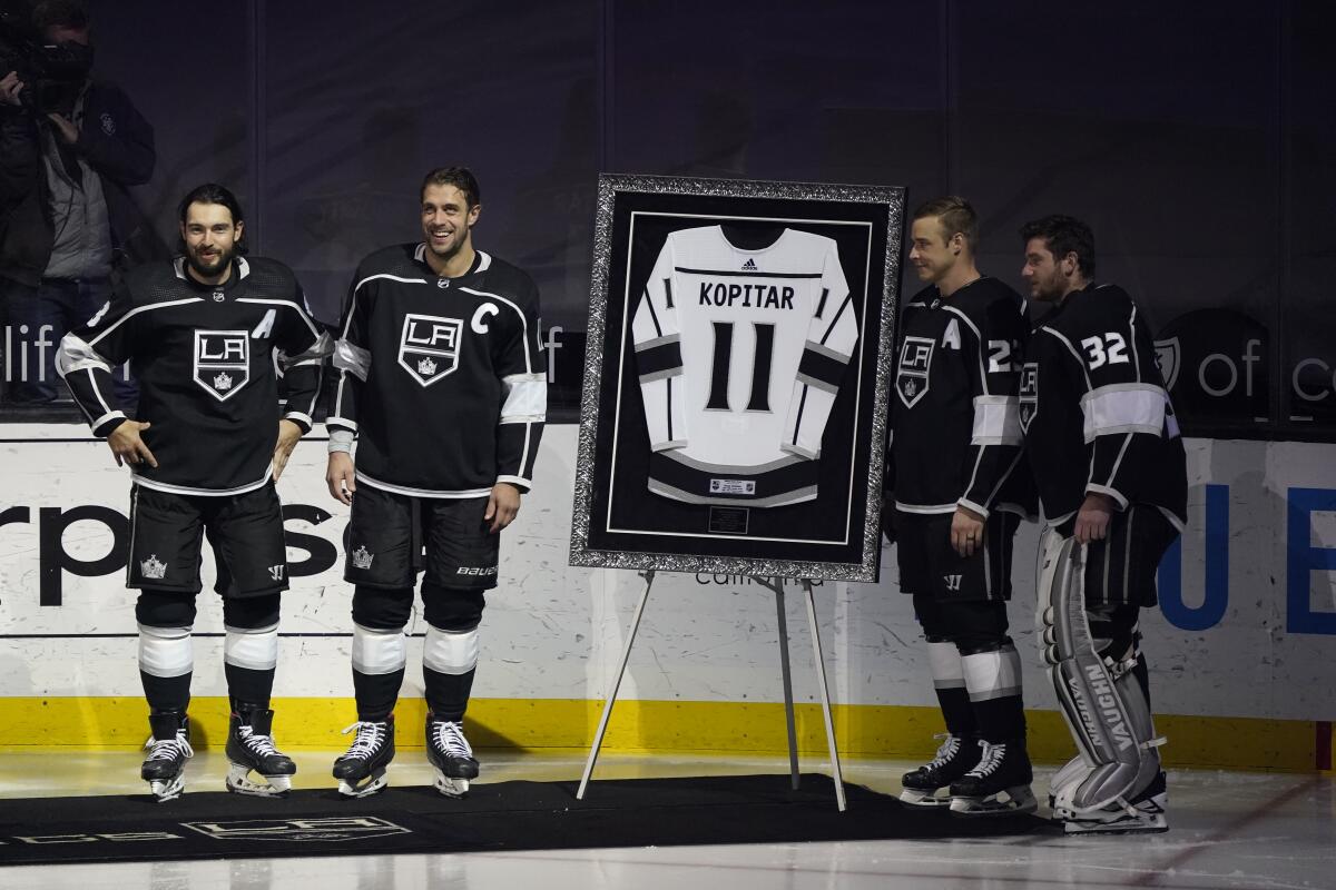 Kings center Anze Kopitar stands with teammates Drew Doughty, Dustin Brown and Jonathan Quick during a pregame ceremony.