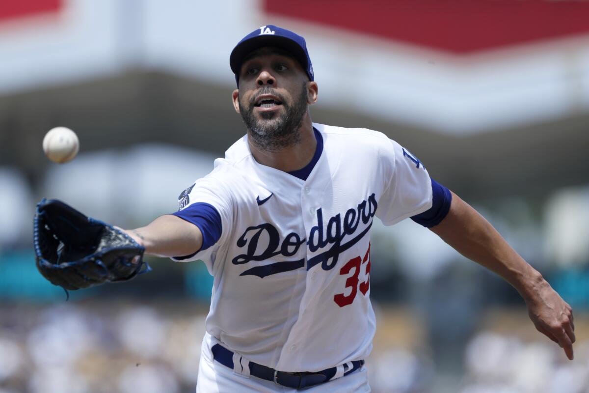 Los Angeles Dodgers starting pitcher David Price reaches out to catch an infield fly ball 