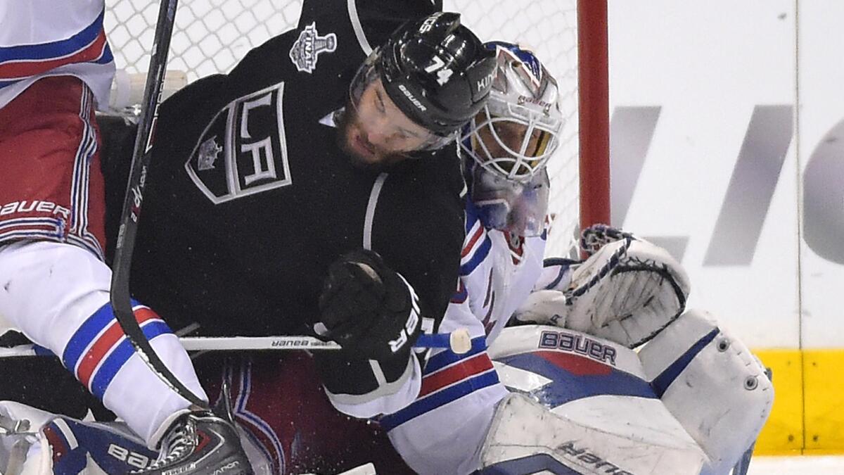 Kings left wing Dwight King falls on New York Rangers goalie Henrik Lundqvist as the Kings score their third goal of Game 2 of the Stanley Cup Final. Lundqvist was upset the goal was allowed, saying he didn't have a chance to make a save on the play.