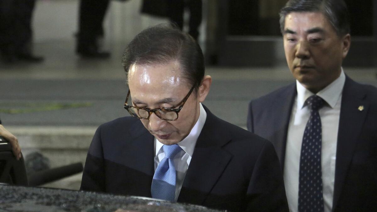 Former South Korean President Lee Myung-bak, leaves the Seoul Central District Prosecutors Office after being questioned by investigators on March 15.