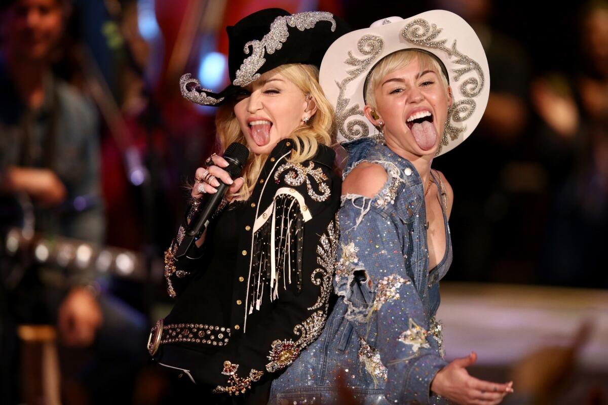 Madonna, left, joins Miley Cyrus during taping of "Miley Cyrus: MTV Unplugged." The show begins airing Jan. 29.