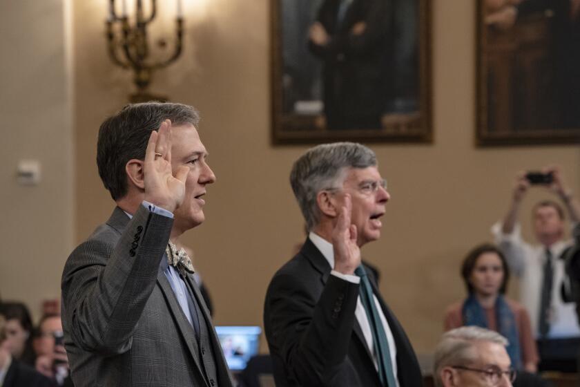 Career Foreign Service officer George Kent, left, and top U.S. diplomat in Ukraine William Taylor, right, are sworn in to testify before the House Intelligence Committee on Capitol Hill in Washington, Wednesday, Nov. 13, 2019, during the first public impeachment hearings on President Donald Trump's efforts to tie U.S. aid for Ukraine to investigations of his political opponents. (AP Photo/(AP Photo/J. Scott Applewhite)