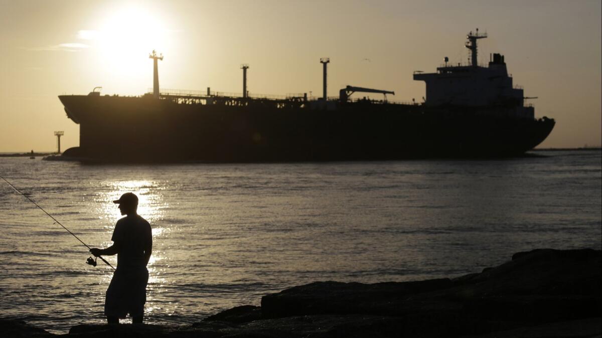 An oil tanker enters a channel near Port Aransas, Texas, heading for the Port of Corpus Christi.