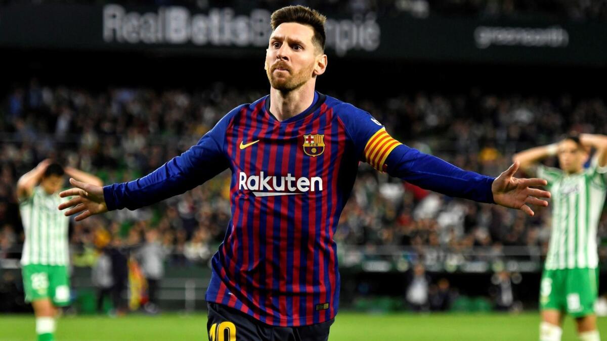 Lionel Messi celebrates after giving FC Barcelona a 4-1 lead against Real Betis on March 17.