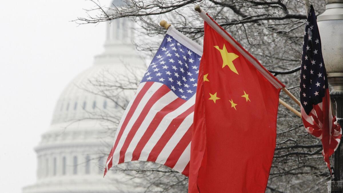 U.S. and Chinese flags in Washington. President Trump's tariff order on Chinese goods sent markets plummeting.