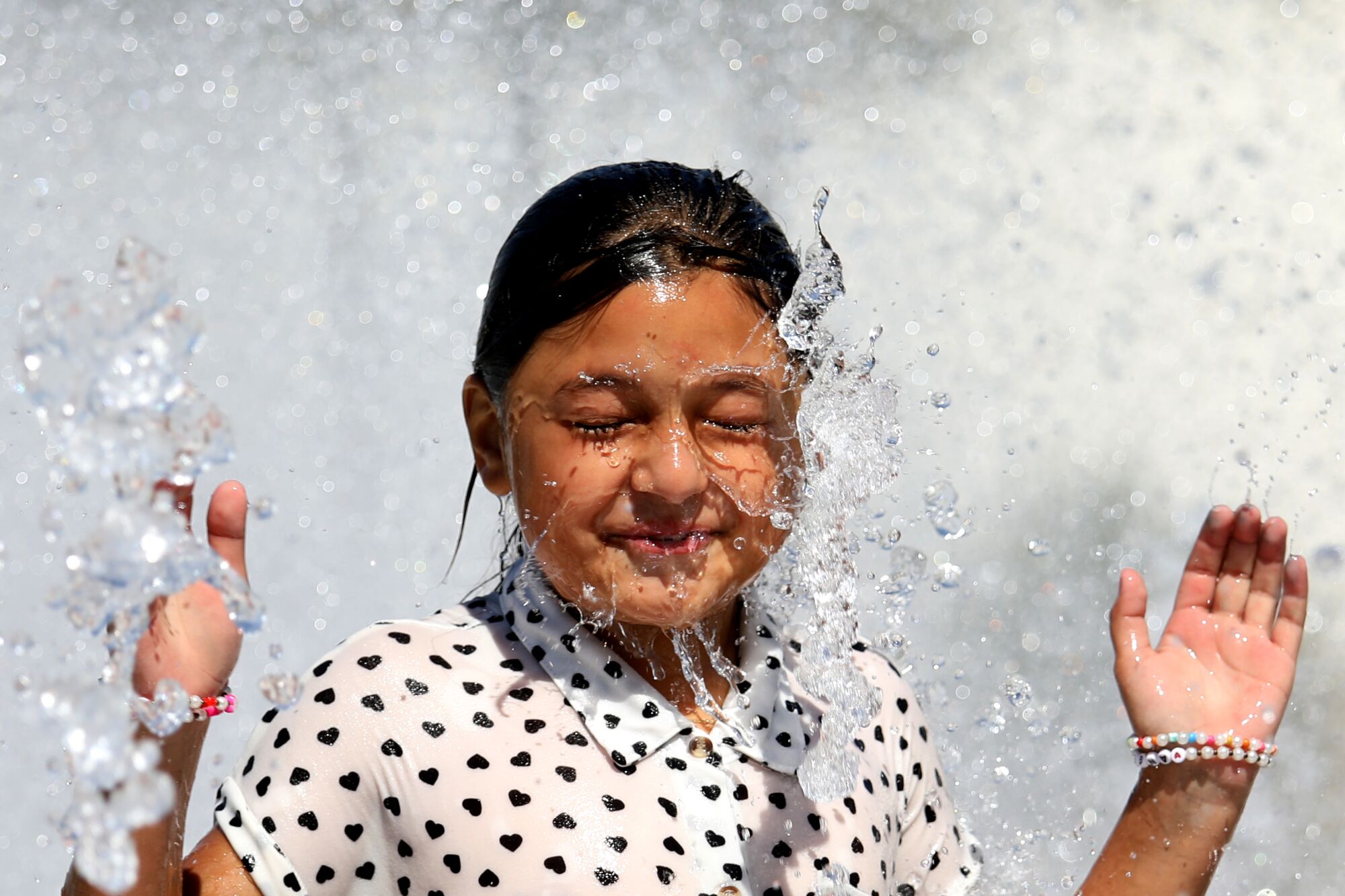 Crisel (cq) Alvaro, 9, of Los Angeles, cools off in the splash pad at Magic Johnson Park in Willowbrook.