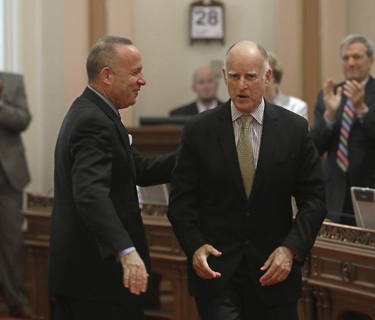 Senate President Pro Tem Darrell Steinberg (D-Sacramento), left, thanks Gov. Jerry Brown during a ceremony honoring Steinberg, who is leaving the Senate due to term limits.