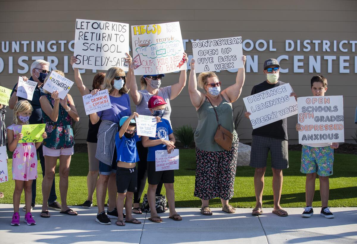 Parents and students hold a rally at the Huntington Beach City School District on Tuesday to protest reopening plans.