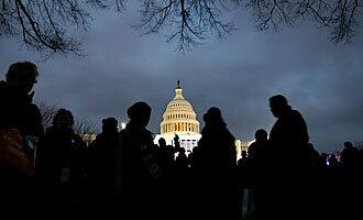 Crowds gather near the main grandstand in front of the U.S. Capitol the night before the inauguration of Barack Obama.
