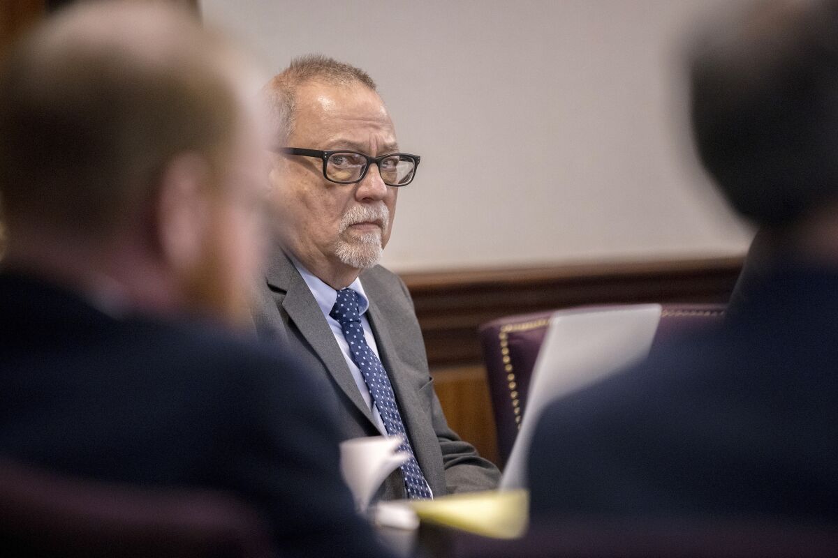 Greg McMichael, center, listens to arguments during the trial of himself, his son Travis McMichael, and a neighbor, William "Roddie" Bryan in the Glynn County Courthouse, Tuesday, Nov. 9, 2021, in Brunswick, Ga. The three are charged with the February 2020 slaying of 25-year-old Ahmaud Arbery. (AP Photo/Stephen B. Morton, Pool)