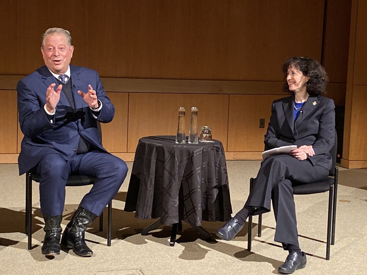 Gore addresses a packed crowd at the Salk Institute on Dec. 3, alongside the evening’s moderator, UCSD executive vice chancellor for academic affairs Elizabeth Simmons.