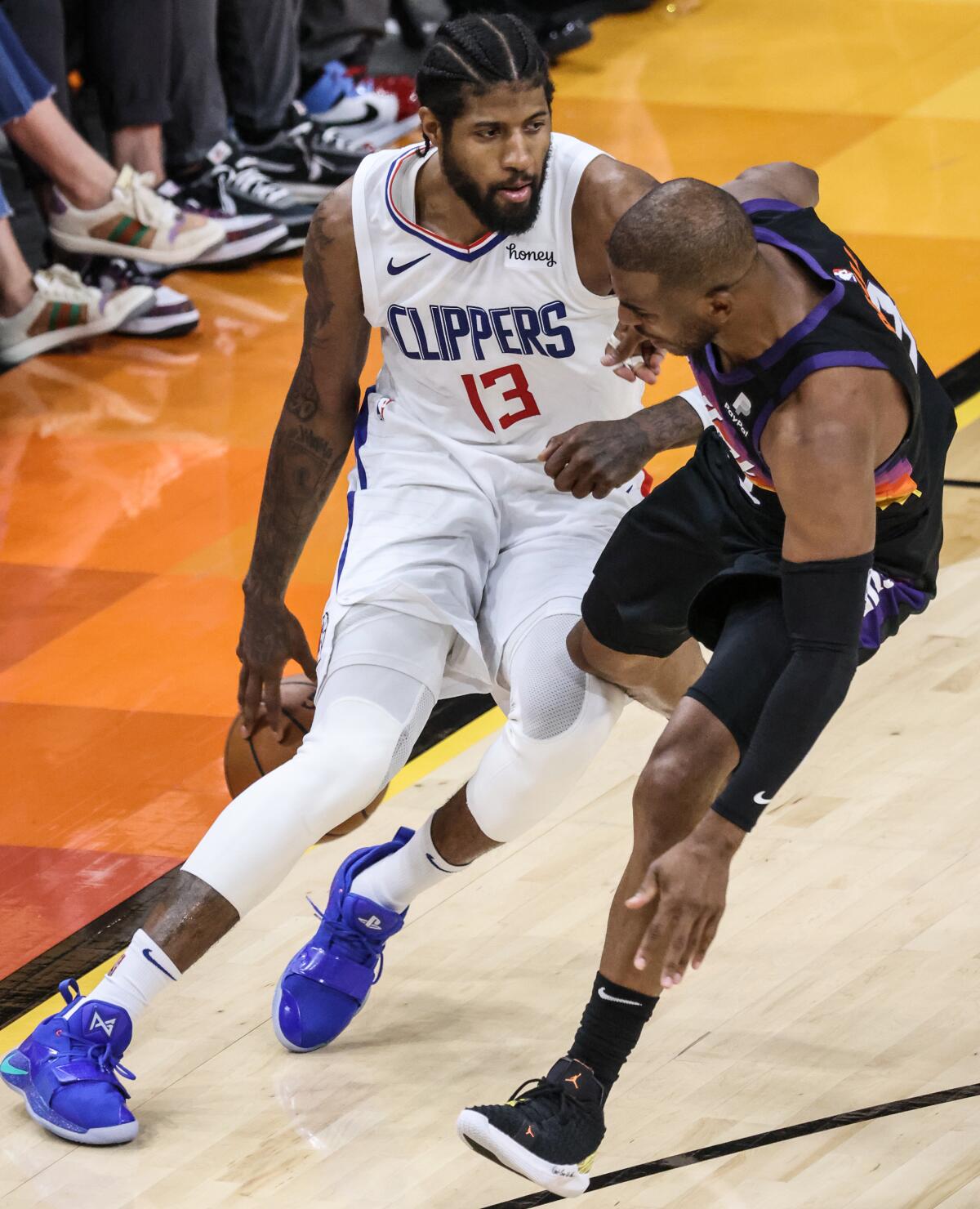 Clippers forward Paul George fends off Suns guard Chris Paul before pulling up for a three-pointer late in Game 5.