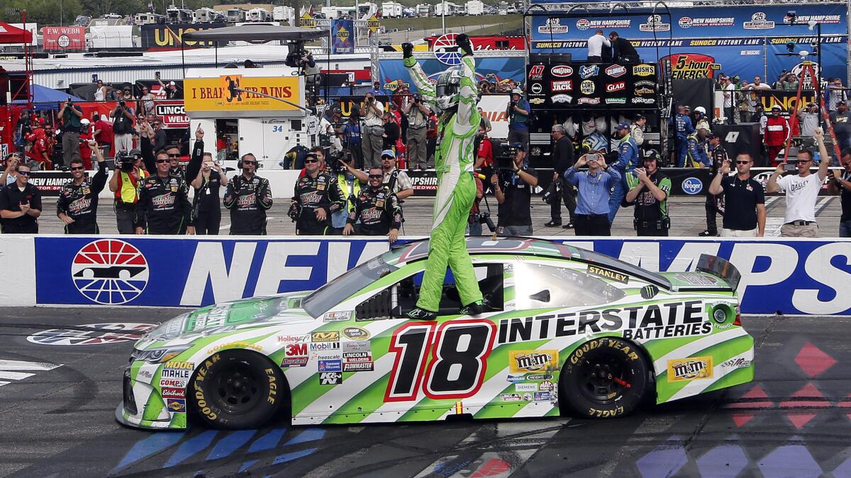 Kyle Busch celebrates after winning Sunday's NASCAR Sprint Cup race at New Hampshire Motor Speedway in Loudon, N.H.