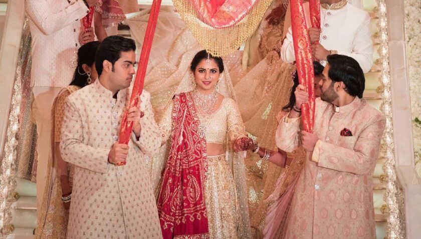 Isha Ambani, seen with two of her brothers, takes part in a traditional marriage ritual as part of a wedding reported to have cost about $100 million.