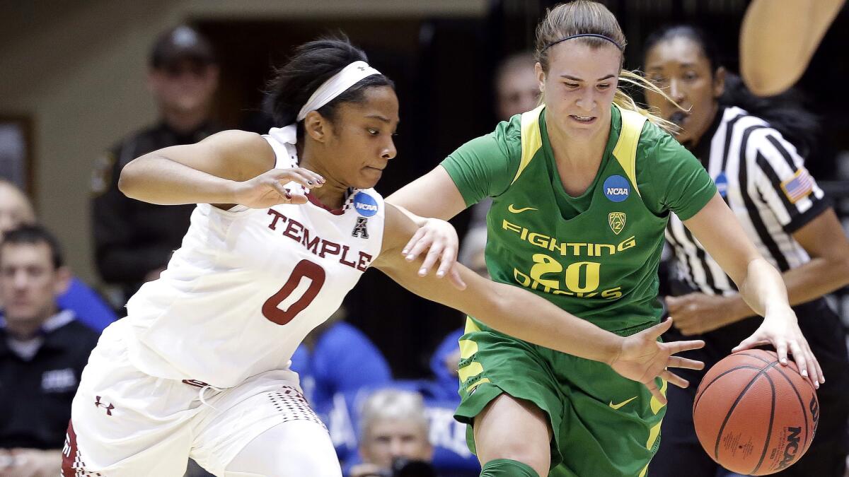 Temple's Alliya Butts (0) and Oregon's Sabrina Ionescu (20) chase after a loose ball during the first half Saturday.