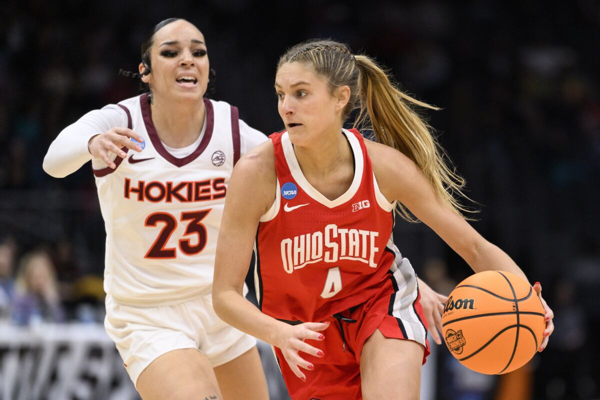 Ohio State guard Jacy Sheldon (4) dribbles as Virginia Tech guard Kayana Traylor (23) defends in the second quarter of an Elite 8 college basketball game of the NCAA Tournament, Monday, March 27, 2023, in Seattle. (AP Photo/Caean Couto)
