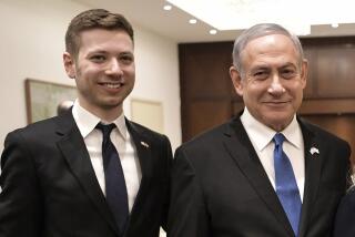 FILE - Israeli Prime Minister Benjamin Netanyahu, second from left, and son Yair, left, pose for a photo in Tel Aviv, Israel, Jan. 23, 2020. An Israeli court ruled Wednesday, Aug. 30, 2023 that Prime Minister Benjamin Netanyahu’s son must compensate a woman who sued him after he implied she was having an affair with his father’s foremost political opponent. The court ordered Netanyahu’s eldest son, Yair Netanyahu, to pay over $34,000 in compensation and $6,000 in legal costs to a woman named Dana Cassidy. (Aleksey Nikolskyi/Sputnik Kremlin Pool Photo via AP, File)