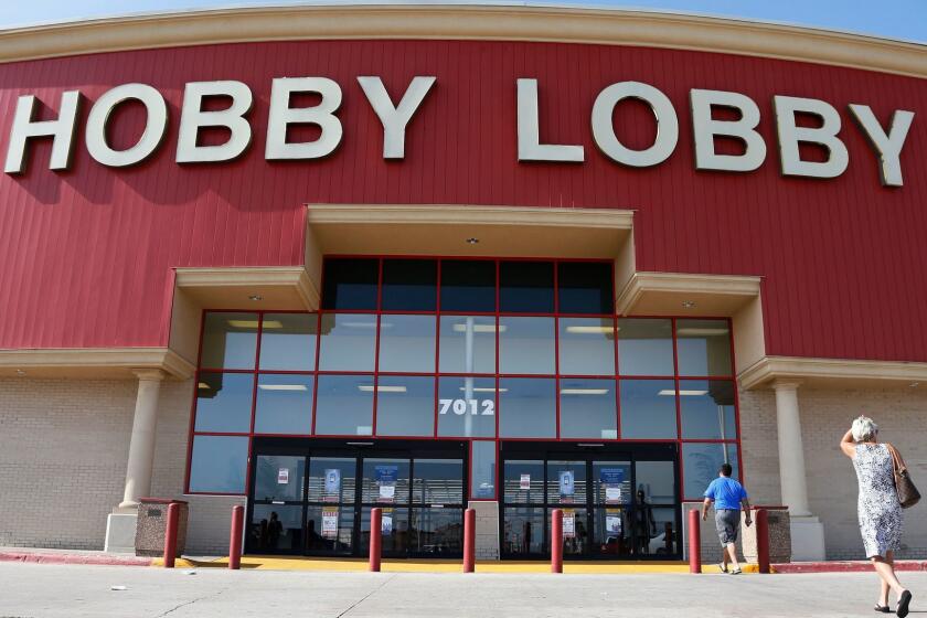 FILE - In this Monday, June 30, 2014, file photo, customers walk to a Hobby Lobby store in Oklahoma City. A Hobby Lobby spokesman told The Associated Press on May 10, 2017, that a report stating the company was considering going out of business is not true. (AP Photo/Sue Ogrocki, File)