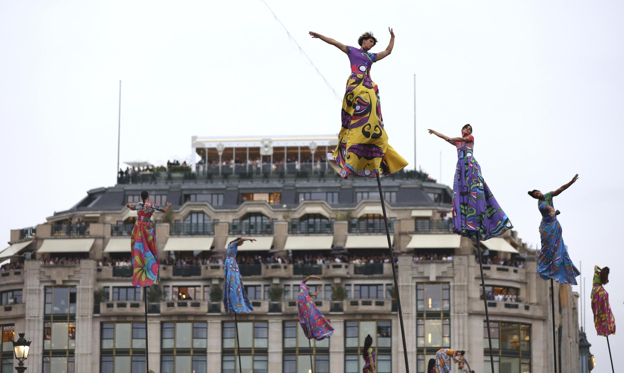 Acrobats performing atop stilts.