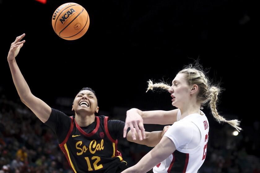 Southern California guard JuJu Watkins (12) reacts after having her shot blocked by Stanford forward Cameron Brink (22) during the first half of an NCAA college basketball game in the championship of the Pac-12 tournament Sunday, March 10, 2024, in Las Vegas. (AP Photo/Ian Maule)