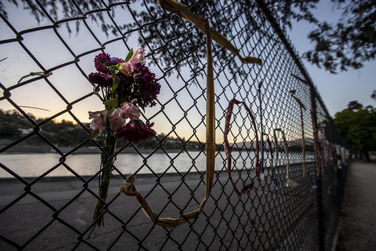 Fresh flowers in the fence memorial.