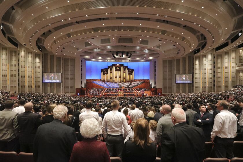 FILE - Mormons listen during The Church of Jesus Christ of Latter-day Saints' twice-annual church conference on Oct. 5, 2019, in Salt Lake City. Tens of thousands of members of The Church of Jesus Christ of Latter-day Saints are scheduled to attend the faith’s biannual conference this weekend, in which senior leaders will address nearly 17 million believers throughout the world from their headquarters in Utah. (AP Photo/Rick Bowmer, File)