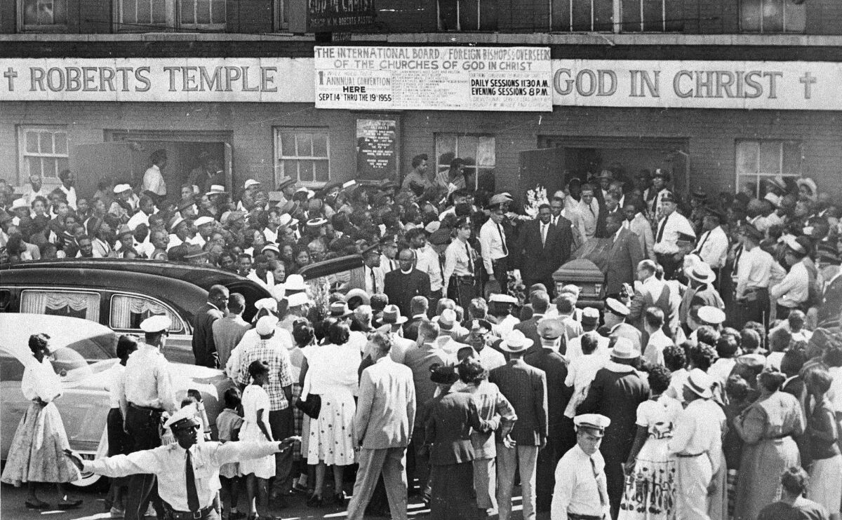 FILE - A large crowd gathers outside the Roberts Temple Church of God In Christ in Chicago, Sept. 6, 1955, as pallbearers carry the casket of Emmett Till, a 14-year-old African-American boy who was slain while on a visit to Mississippi. The African American Cultural Heritage Action Fund is awarding $3 million in grants to help preserve the site and dozens more across the nation. (Chicago Sun-Times via AP)