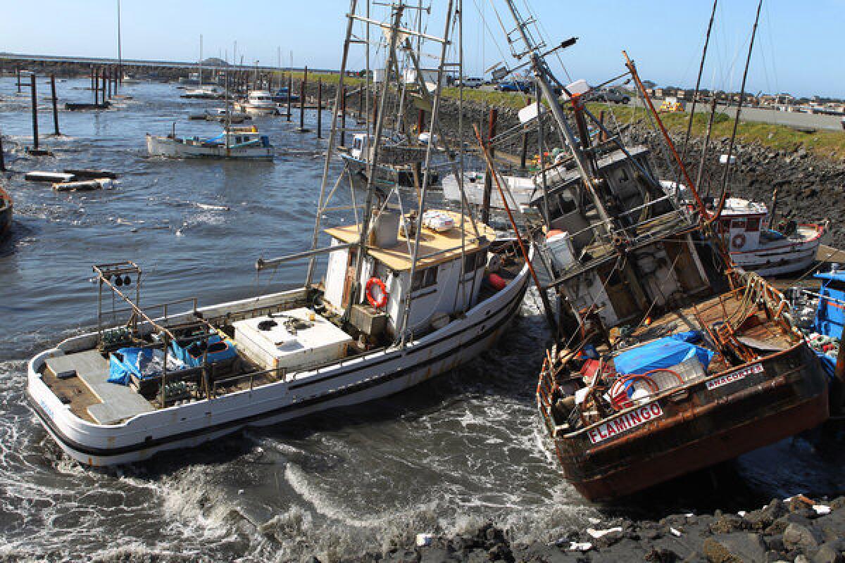 In this March 11, 2011, photo, boats collide with one another after a tsunami surge of water swept through a boat basin in Crescent City, Calif.