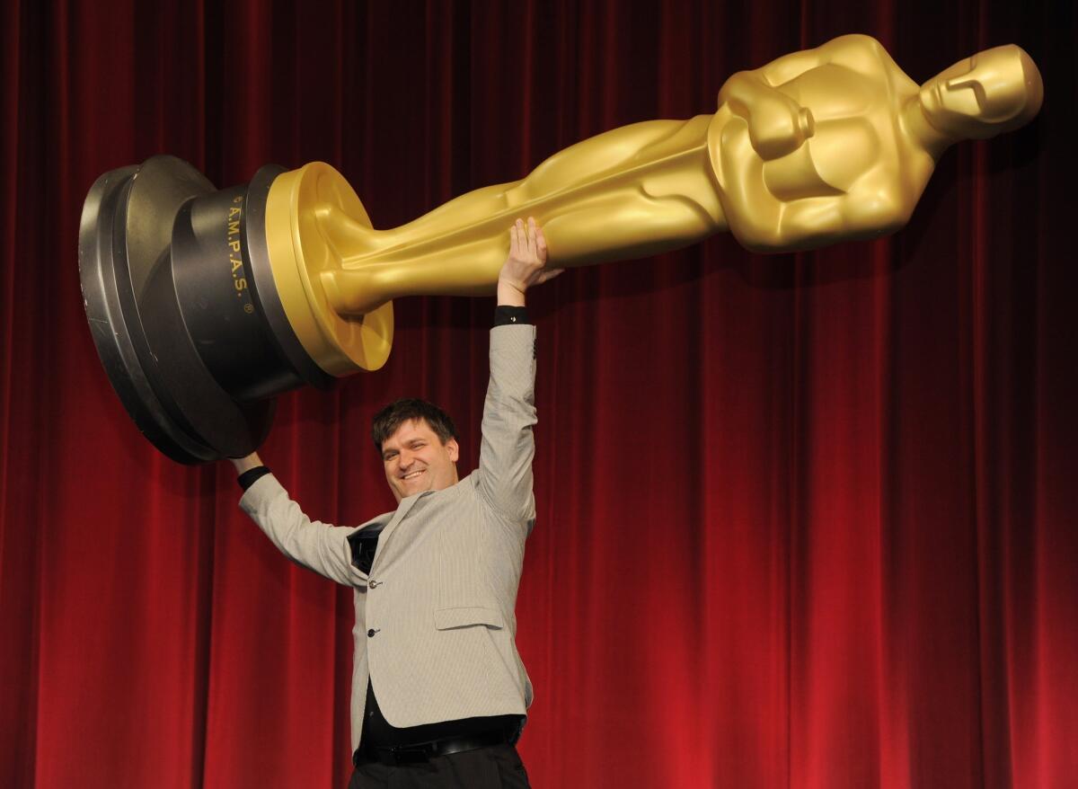 Filmmaker John Mattiuzzi of the School of Visual Arts in New York, a nominee in the Alternative Category for his film "The Compositor," hoists up an Oscar statue for photographers before the Academy of Motion Picture Arts and Sciences 40th Student Academy Awards at the Samuel Goldwyn Theater.