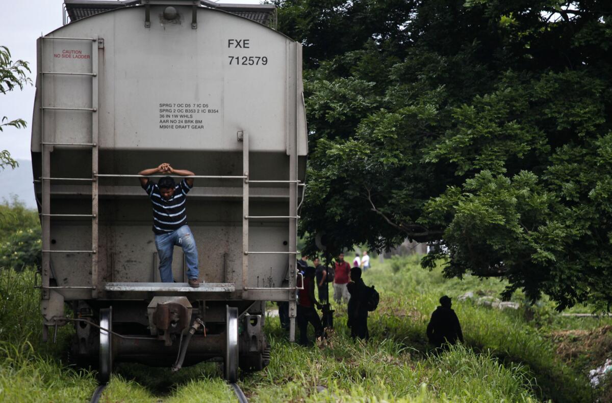 Migrants near Arriaga, Mexico, wait to board La Besta, or The Beast, the name for the infamous train that carries them northward.