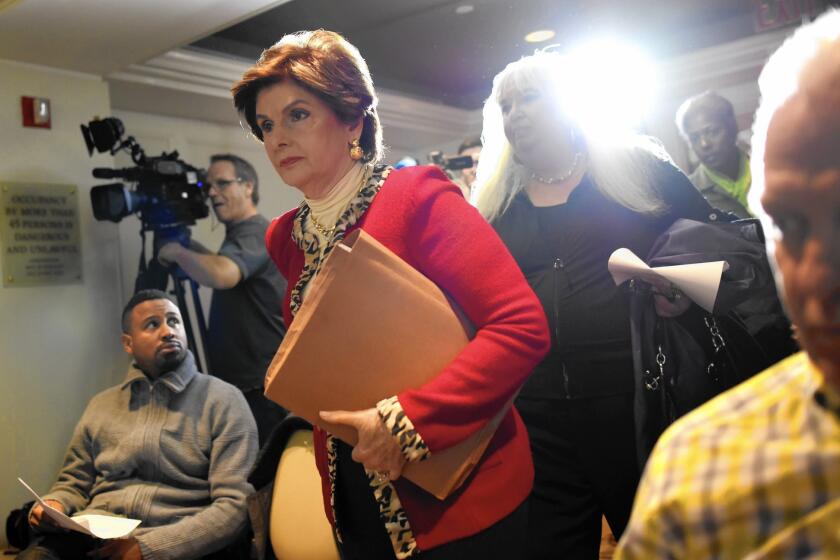 Attorney Gloria Allred walks into a New York news conference with two women who allege they were victims of sexual misconduct by comedian Bill Cosby.