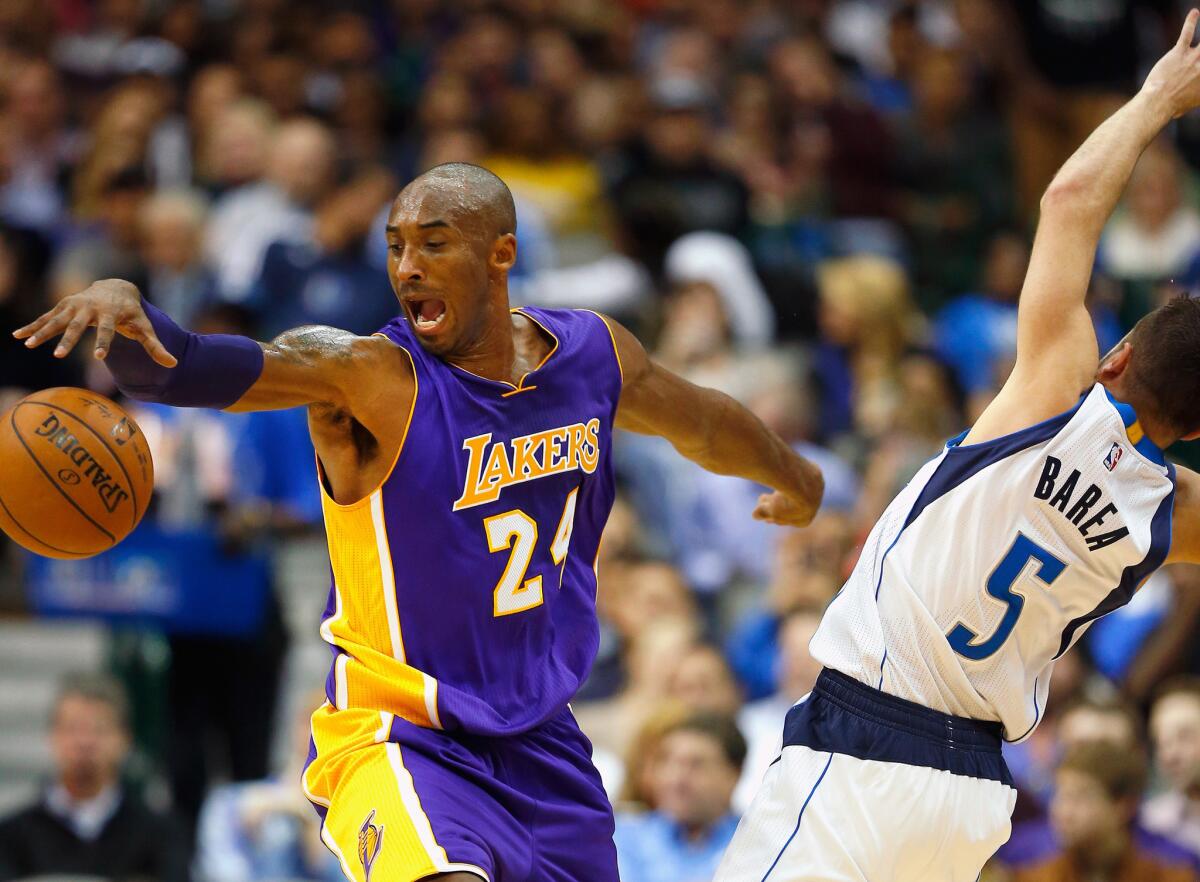 Lakers guard Kobe Bryant is fouled by Mavericks point guard J.J. Barea on a drive in the first half.