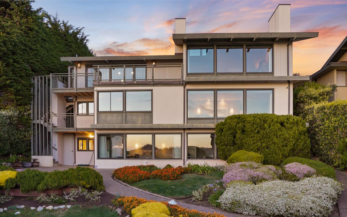 Built in 1981, the three-story home overlooks the ocean and features a path that winds toward the beach.