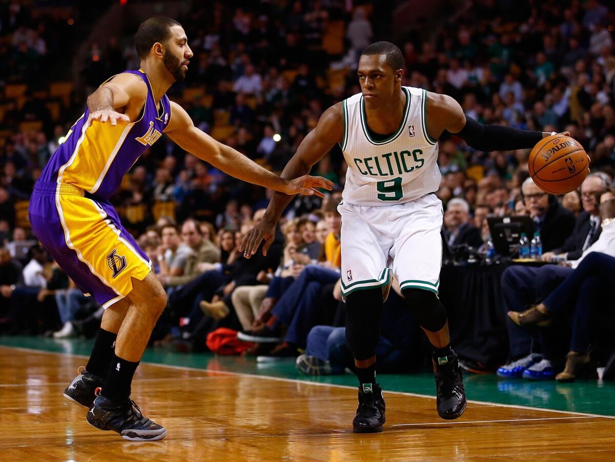 Celtics point guard Rajon Rondo, right, sets up the offense against Lakers point guard Kendall Marshall in a Jan. 17 game in Boston, a Lakers win. It was Rondo's first game back after sitting out nearly a year with a knee injury.