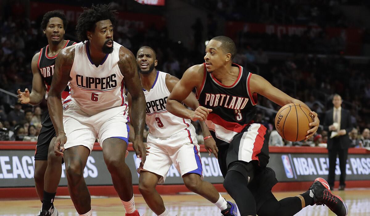 Portland Trail Blazers' C.J. McCollum, right, drives past Clippers' DeAndre Jordan during the second half on Thursday.