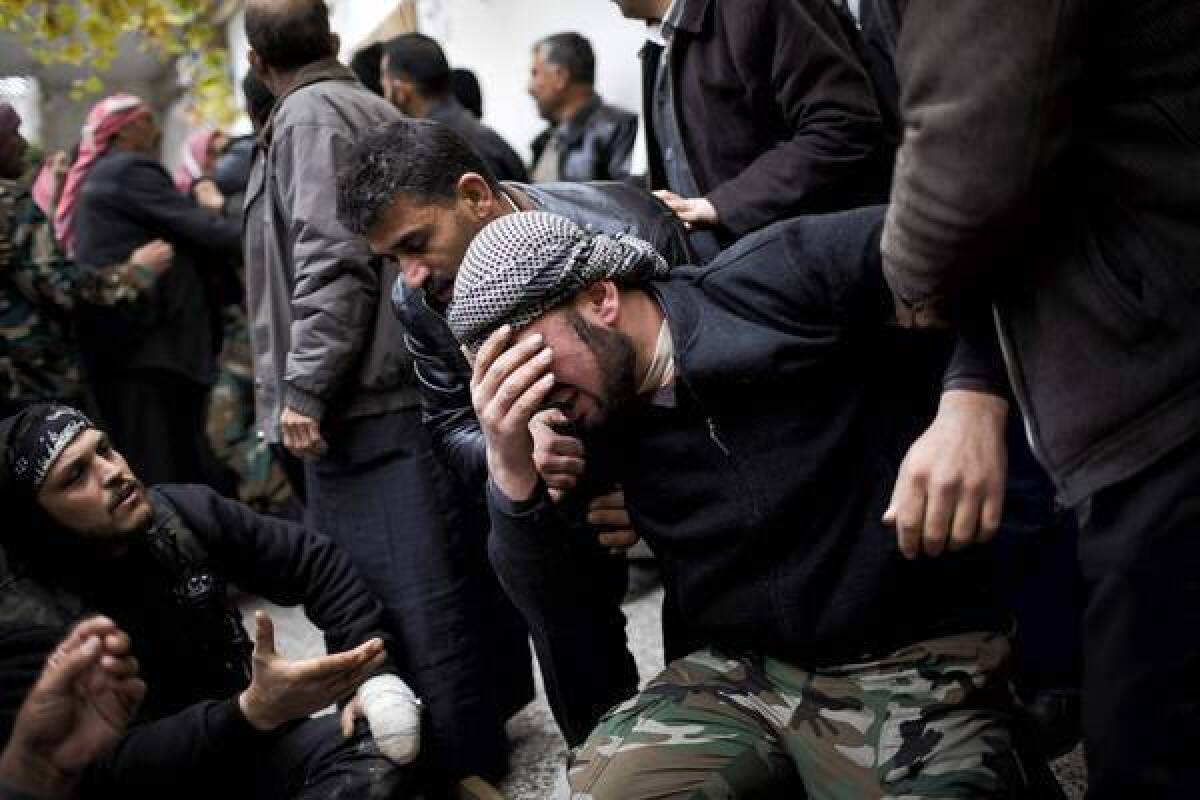 A Syrian rebel fighter cries during the funeral of a comrade in the town of Azaz. A Russian diplomat predicted that the fighting would become even more intense.