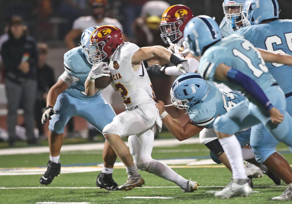 Estancia's Jeff Brown (22) runs for a first down during a nonleague football game against University on Thursday.