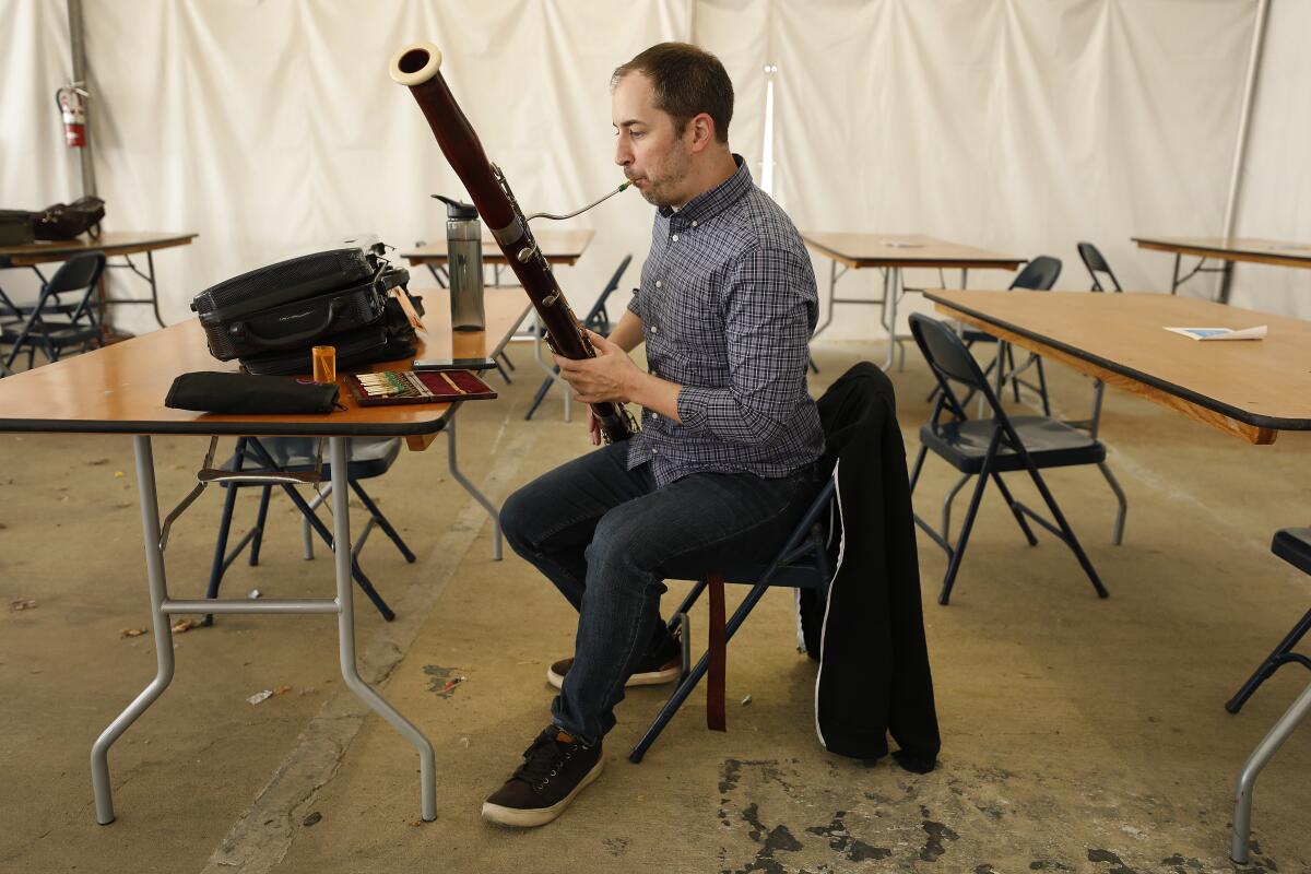 A bassoonist warms up.