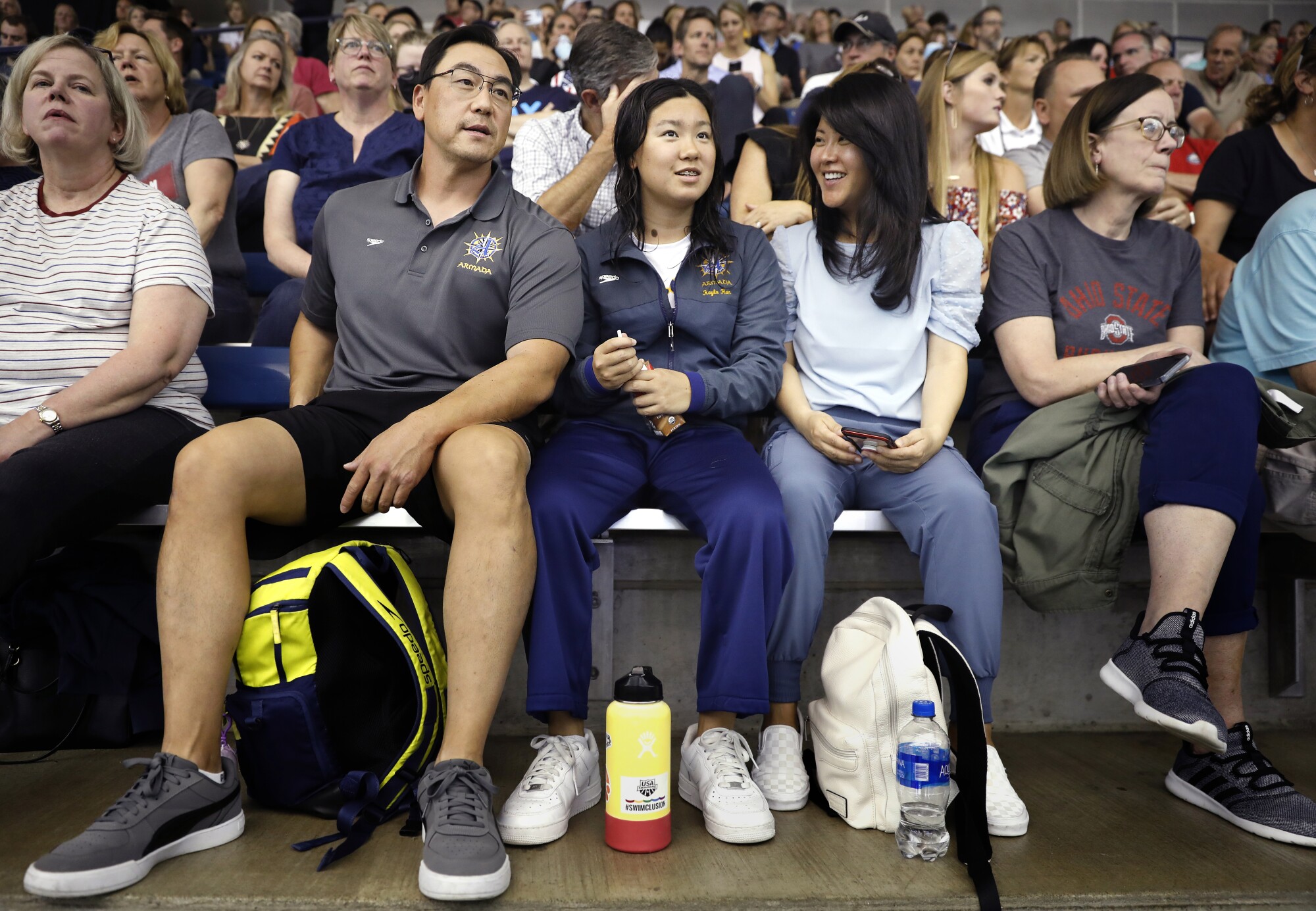 Kayla Han sits with her parents Dan and Kim in the stands after competing in the 2022 Phillips 66 International Team Trials.